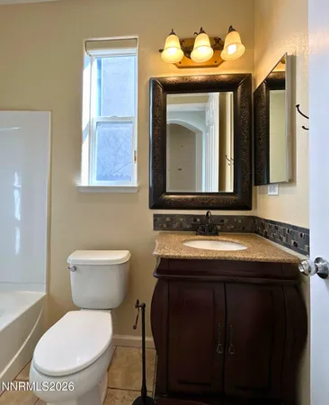 a view of a bathroom with mirror and shower