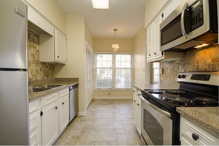 4505 Harding Pike, Unit 106 Nashville, TN 37205 - Photo 12 of 22 a kitchen with stainless steel appliances granite countertop a stove and a microwave