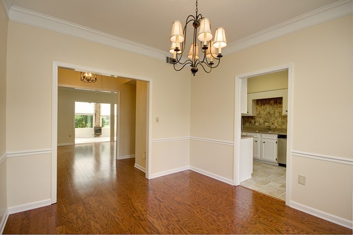 4505 Harding Pike, Unit 106 Nashville, TN 37205 - Photo 15 of 22 a view of a hallway with wooden floor and a kitchen