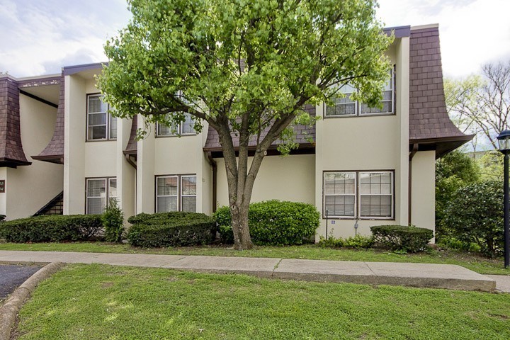 4505 Harding Pike, Unit 106 Nashville, TN 37205 - Photo 22 of 22 a front view of a house with a yard and trees