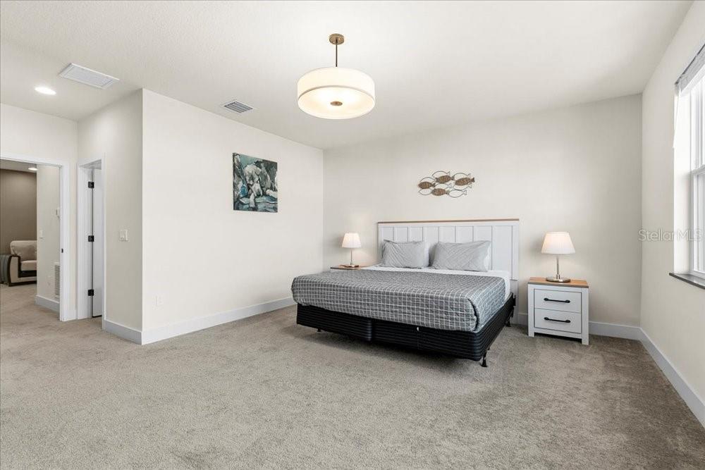 1385 Peaceful Way Clermont, FL 34714 - Photo 14 of 28 a spacious bedroom with a bed and a window