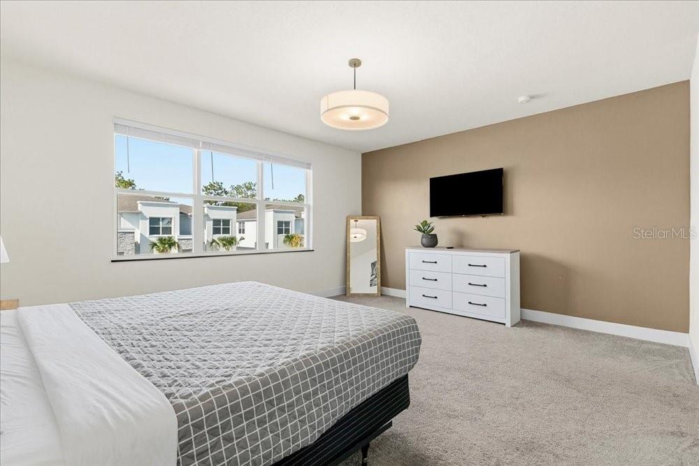 1385 Peaceful Way Clermont, FL 34714 - Photo 15 of 28 a bedroom with a bed and a flat screen tv