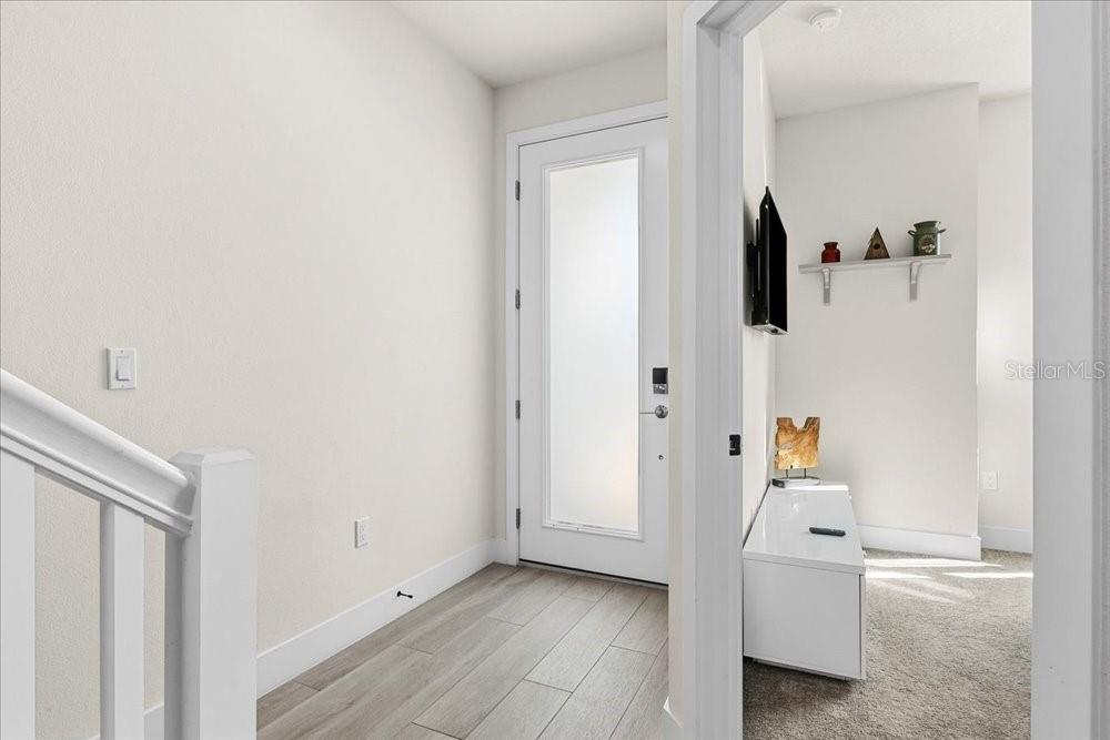 1385 Peaceful Way Clermont, FL 34714 - Photo 3 of 28 a view of a bedroom with a bed and wooden floor