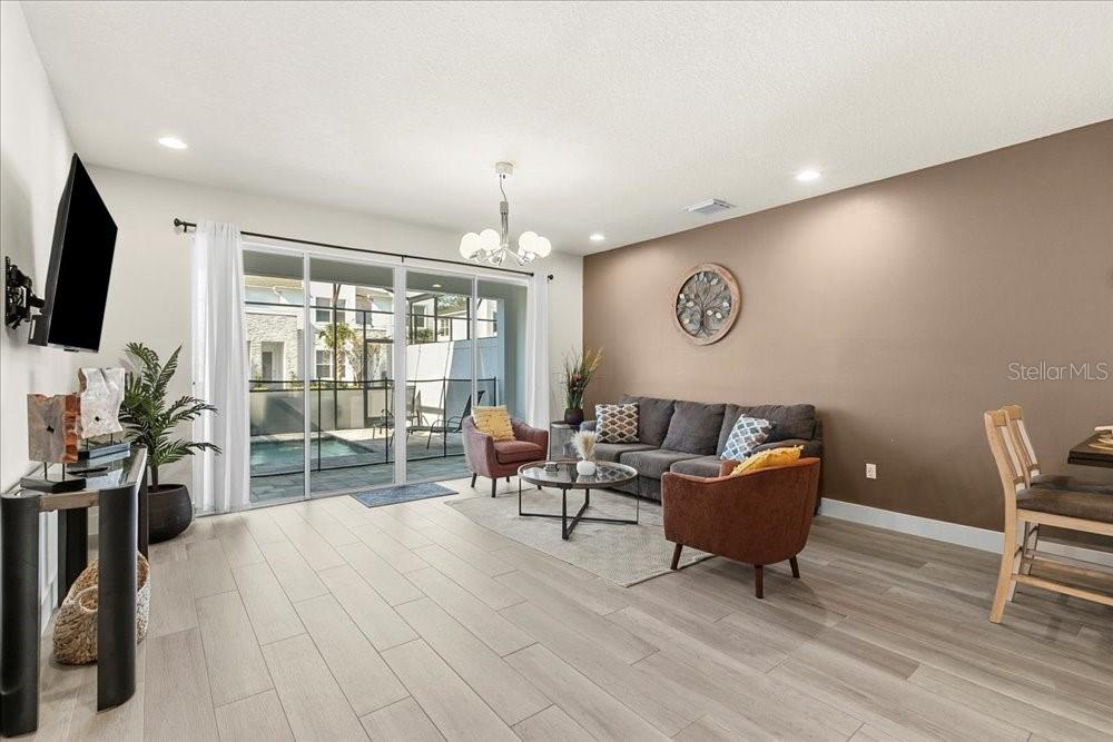 1385 Peaceful Way Clermont, FL 34714 - Photo 9 of 28 a living room with furniture and a flat screen tv