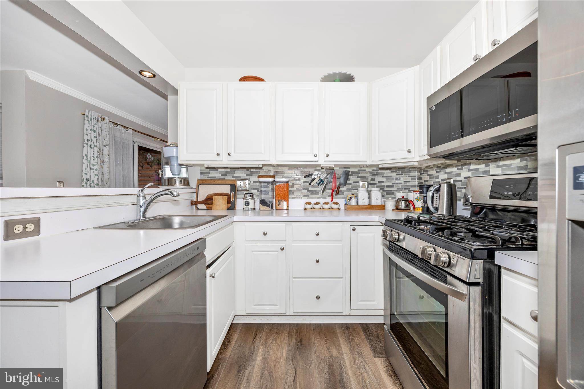125 Timberbrook Lane, Unit 102 Gaithersburg, MD 20878 - Photo 12 of 38 a kitchen with stainless steel appliances a stove sink and cabinets