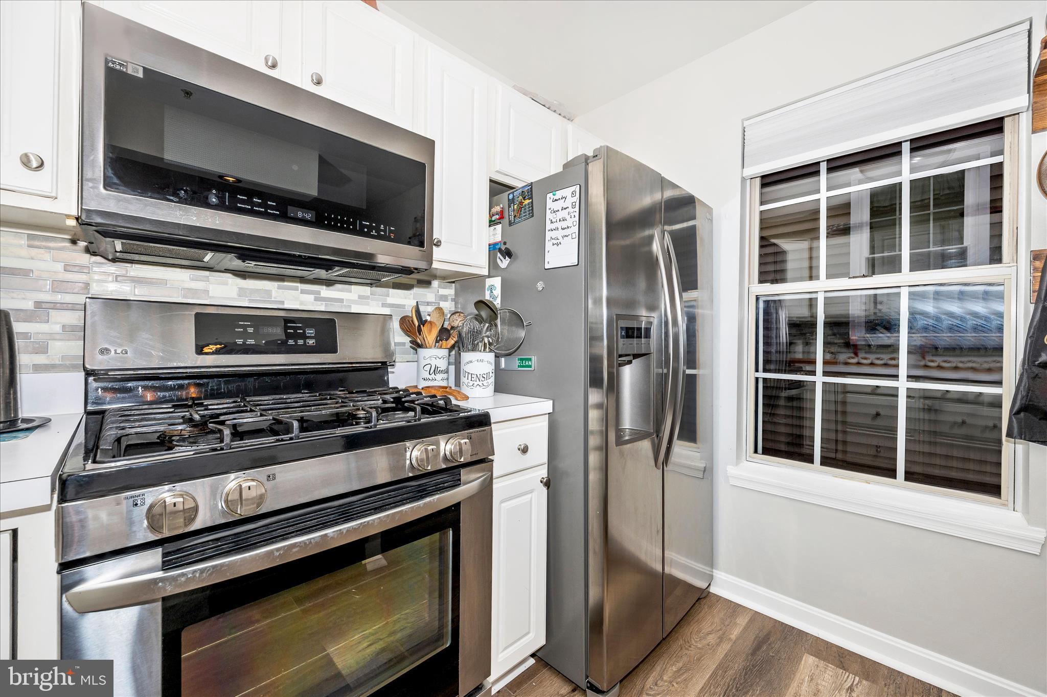 125 Timberbrook Lane, Unit 102 Gaithersburg, MD 20878 - Photo 13 of 38 a kitchen with a stove and a microwave
