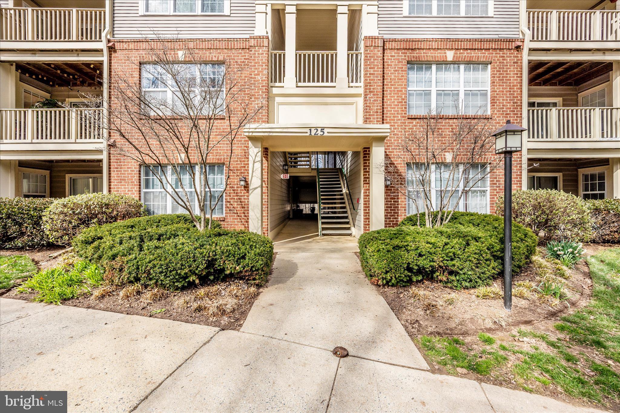 125 Timberbrook Lane, Unit 102 Gaithersburg, MD 20878 - Photo 2 of 38 a front view of a house with garden