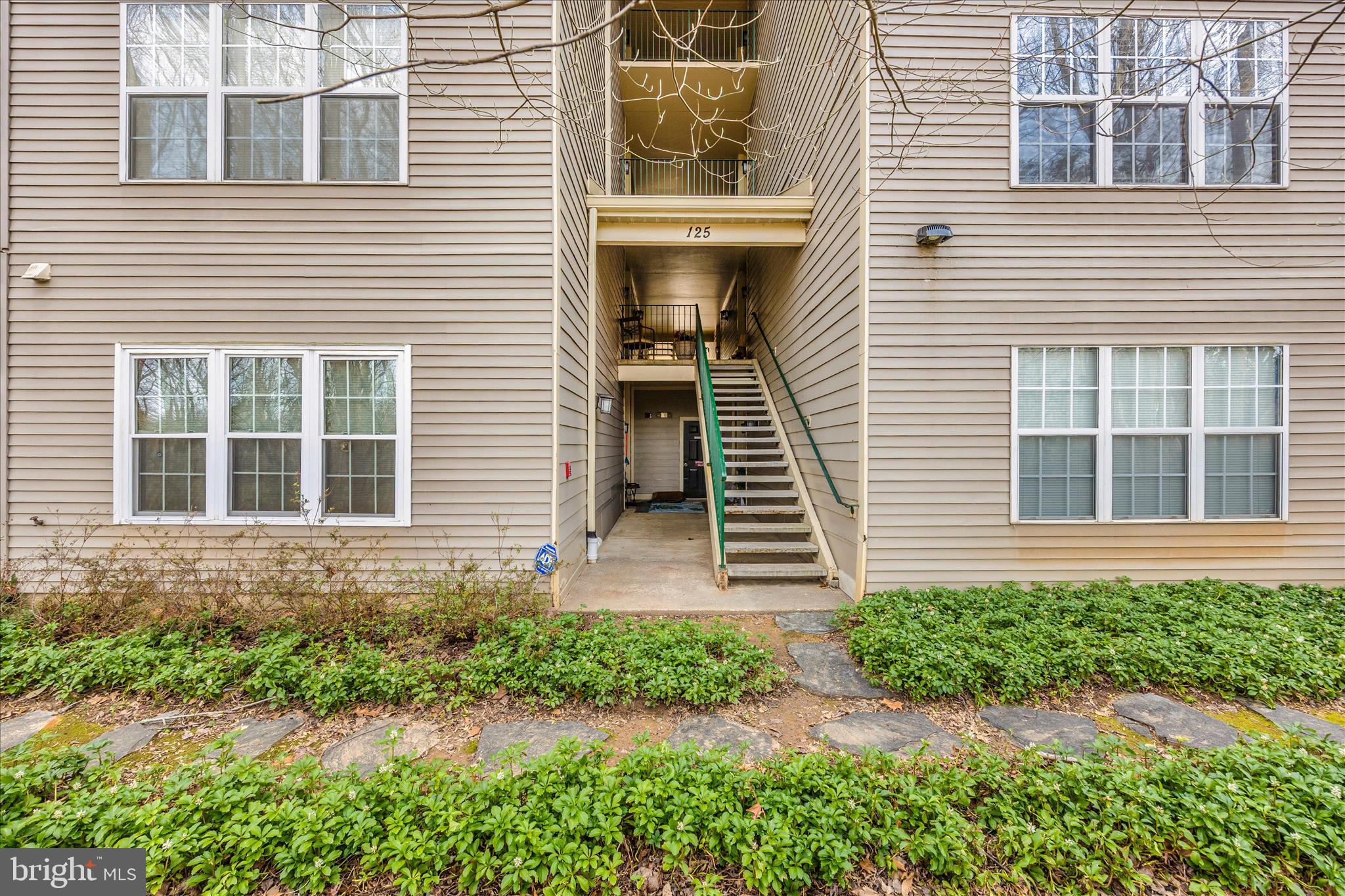 125 Timberbrook Lane, Unit 102 Gaithersburg, MD 20878 - Photo 28 of 38 a front view of a house with a yard and porch