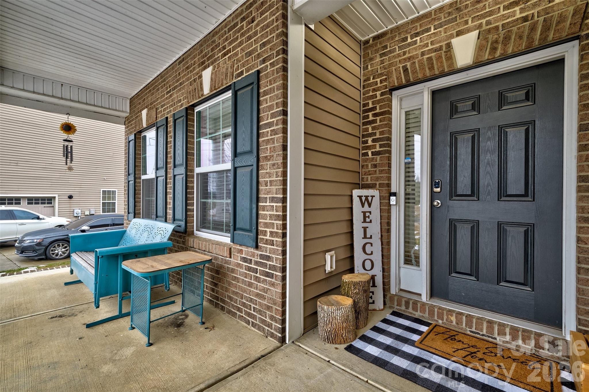 3078 Rhododendron Place Lake Wylie, SC 29710 - Photo 2 of 43 a view of a brick house with chairs and floor to ceiling window