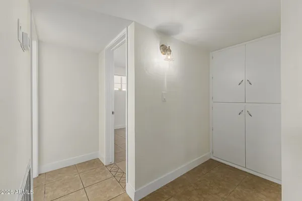 an empty room with a ceiling fan and a window