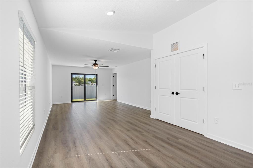 13053 Trapper John Road Weeki Wachee, FL 34614 - Photo 3 of 7 wooden floor in an empty room with a window