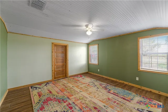 a bedroom with bed and a window