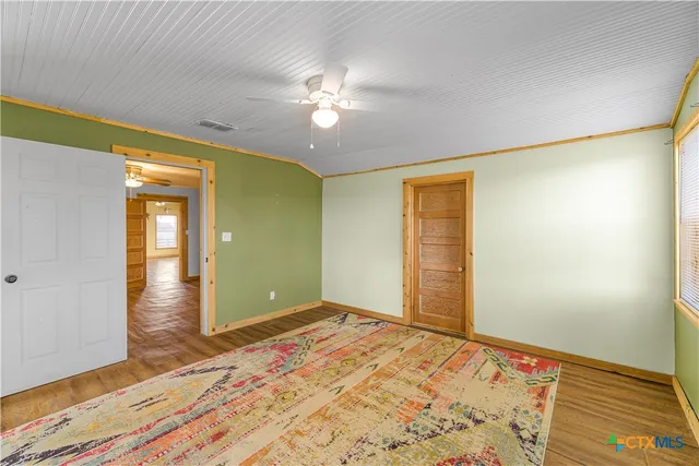 a view of a room with wooden floor and natural light