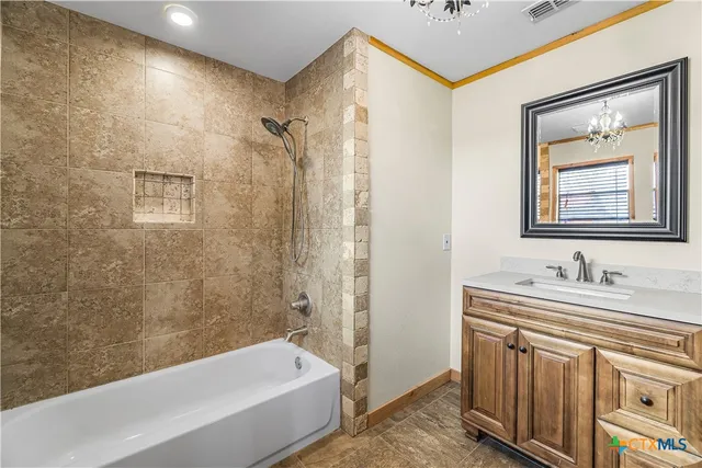 a bathroom with a tub a sink and mirror
