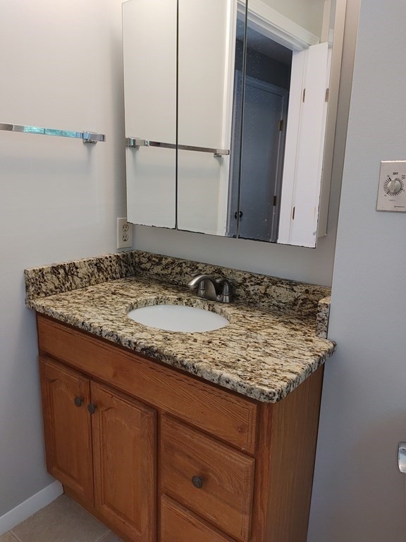 116 Russet Lane, Unit 116 Boxborough, MA 01719 - Photo 14 of 22 a bathroom with a granite countertop sink and a mirror