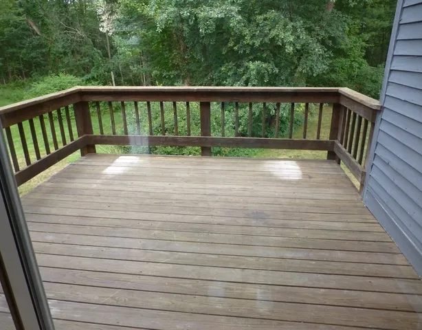 a view of balcony with wooden floor