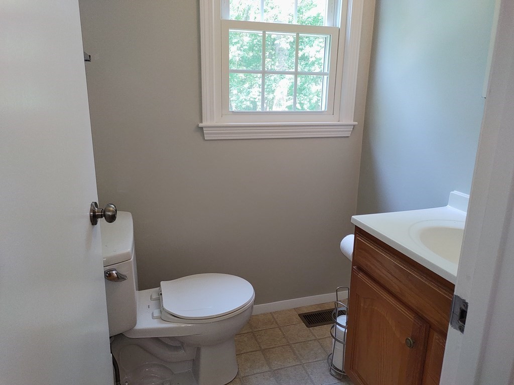 116 Russet Lane, Unit 116 Boxborough, MA 01719 - Photo 9 of 22 a bathroom with a toilet a sink and a window