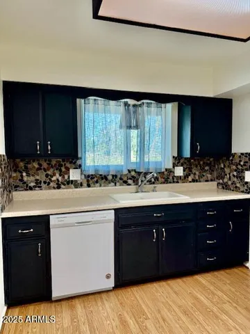 a spacious bathroom with a sink and a mirror