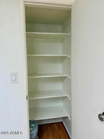 a view of walk in closet with empty racks