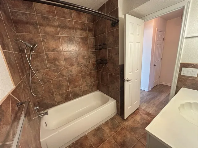 a bathroom with a bathtub and shower