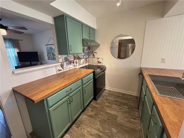 a bathroom with a sink a mirror and vanity