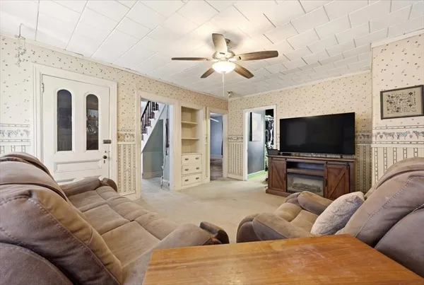 a living room with furniture and a flat screen tv