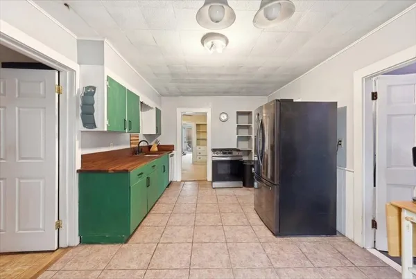 a kitchen with stainless steel appliances granite countertop a refrigerator and a sink