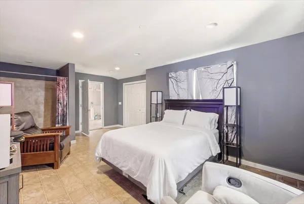 a bedroom with a bed and large window