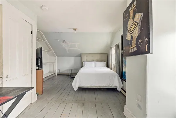 a bedroom with a bed and a dresser