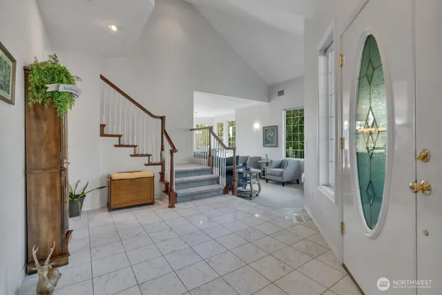 a view of living room filled with furniture and large windows