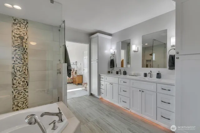 a large bathroom with a double vanity sink toilet and shower