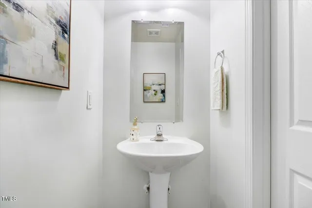 an empty room with windows and cabinet