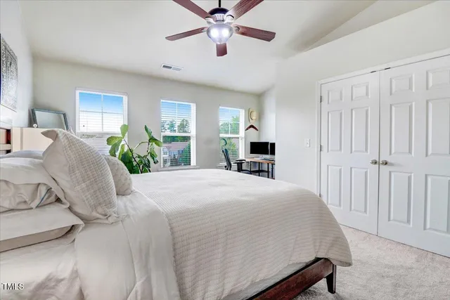a front view of a house with yard and green space