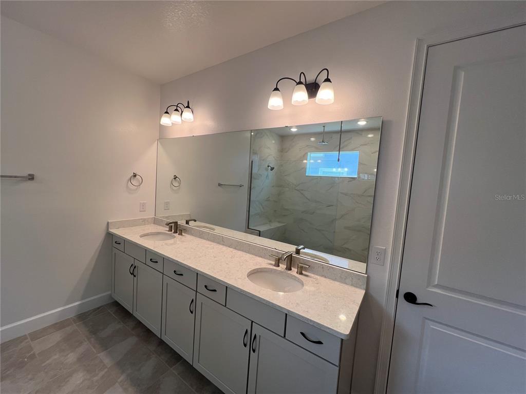 931 Signet Drive Apollo Beach, FL 33572 - Photo 12 of 22 a bathroom with a double vanity sink and a mirror