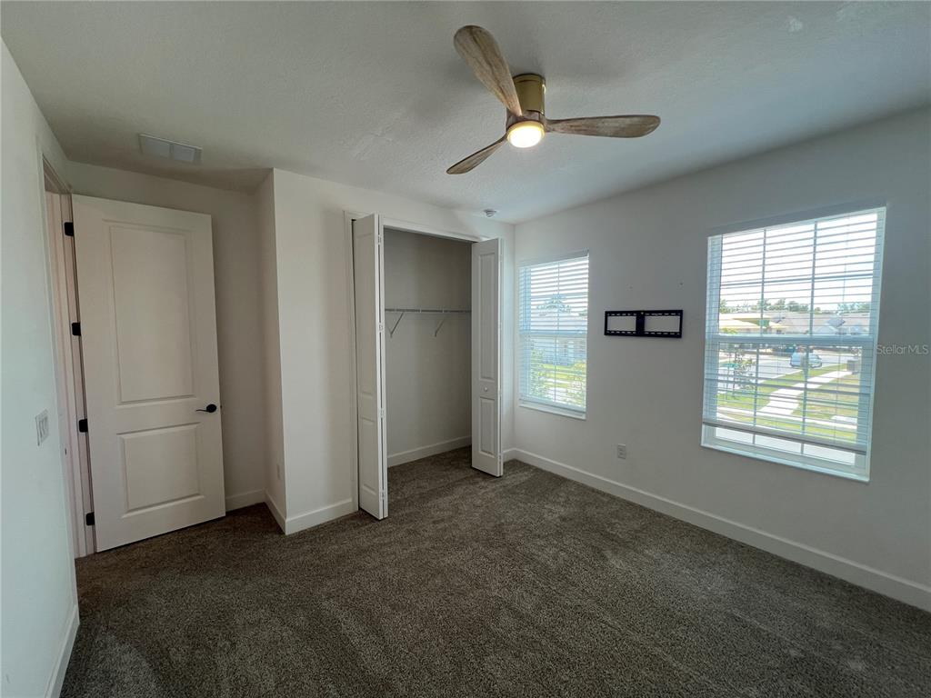 931 Signet Drive Apollo Beach, FL 33572 - Photo 20 of 22 an empty room with closet and windows
