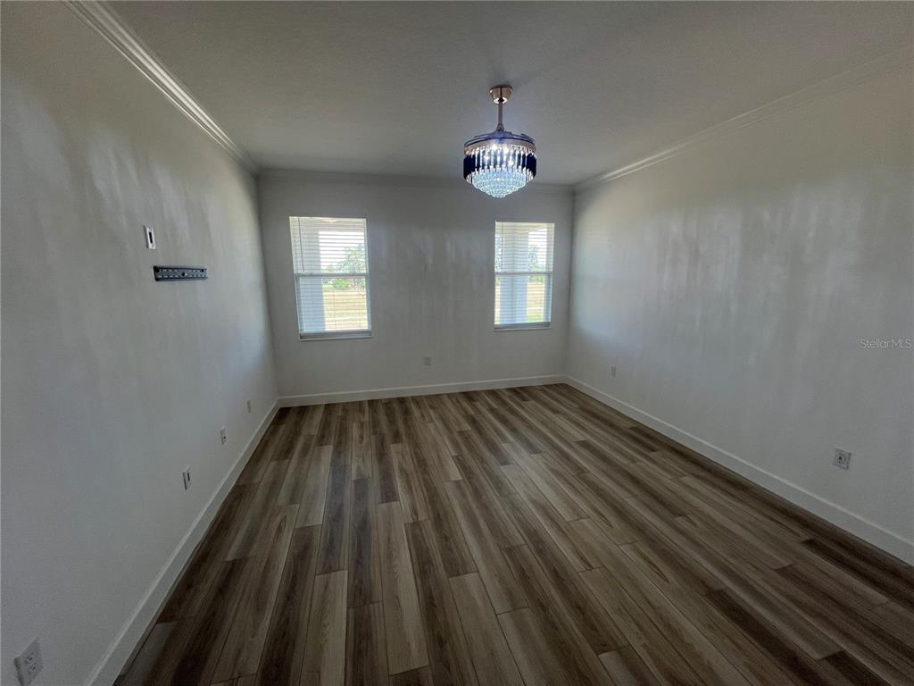 931 Signet Drive Apollo Beach, FL 33572 - Photo 9 of 22 wooden floor in an empty room with a window