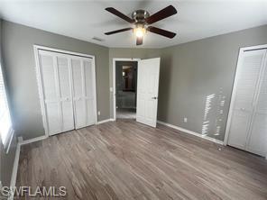 7786 Scarlet Court Naples, FL 34104 - Photo 12 of 14 an empty room with wooden floor and a ceiling fan