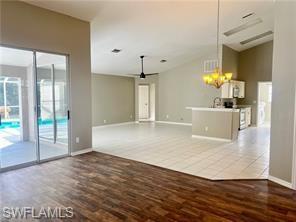 7786 Scarlet Court Naples, FL 34104 - Photo 3 of 14 a view of a kitchen with a sink and wooden floor