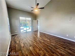 7786 Scarlet Court Naples, FL 34104 - Photo 7 of 14 an empty room with wooden floor and windows