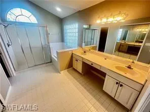 a spacious bathroom with a double vanity sink and a mirror