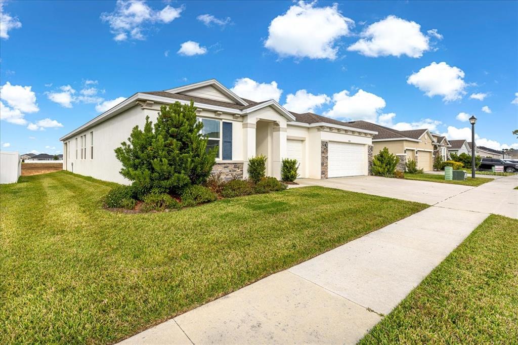 5851 Southwest 85th Place Ocala, FL 34476 - Photo 49 of 57 a view of a white house with a big yard and a fountain