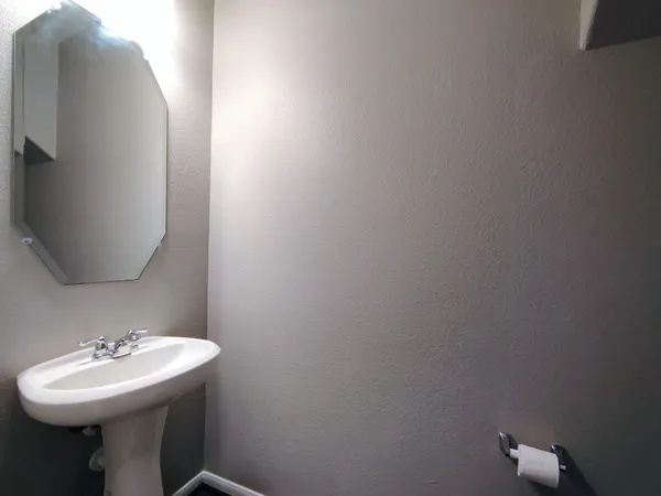 a bathroom with a sink a toilet and mirror