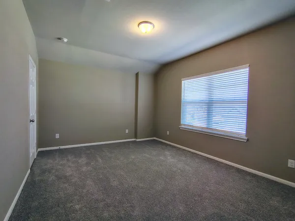 an empty room with a empty space and windows