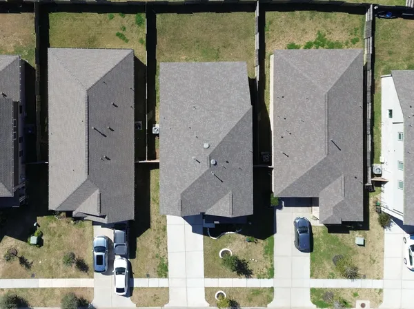 an aerial view of residential houses with outdoor space