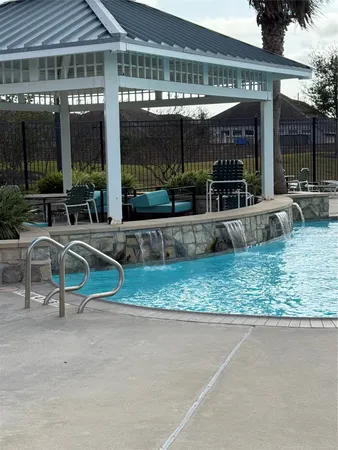 an outdoor space with swimming pool and furniture