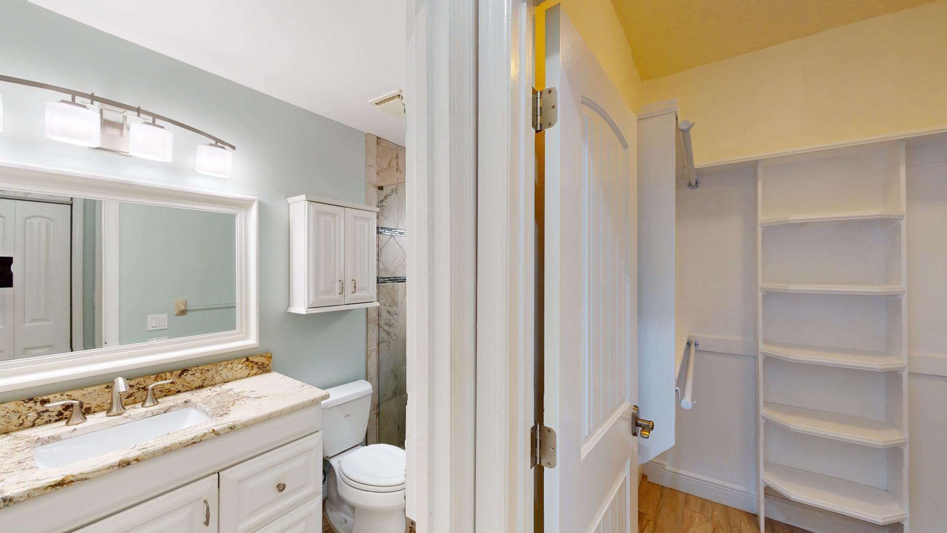 959 N Highway Indialantic, FL 32903 - Photo 50 of 70 a bathroom with a granite countertop sink toilet a mirror and shower