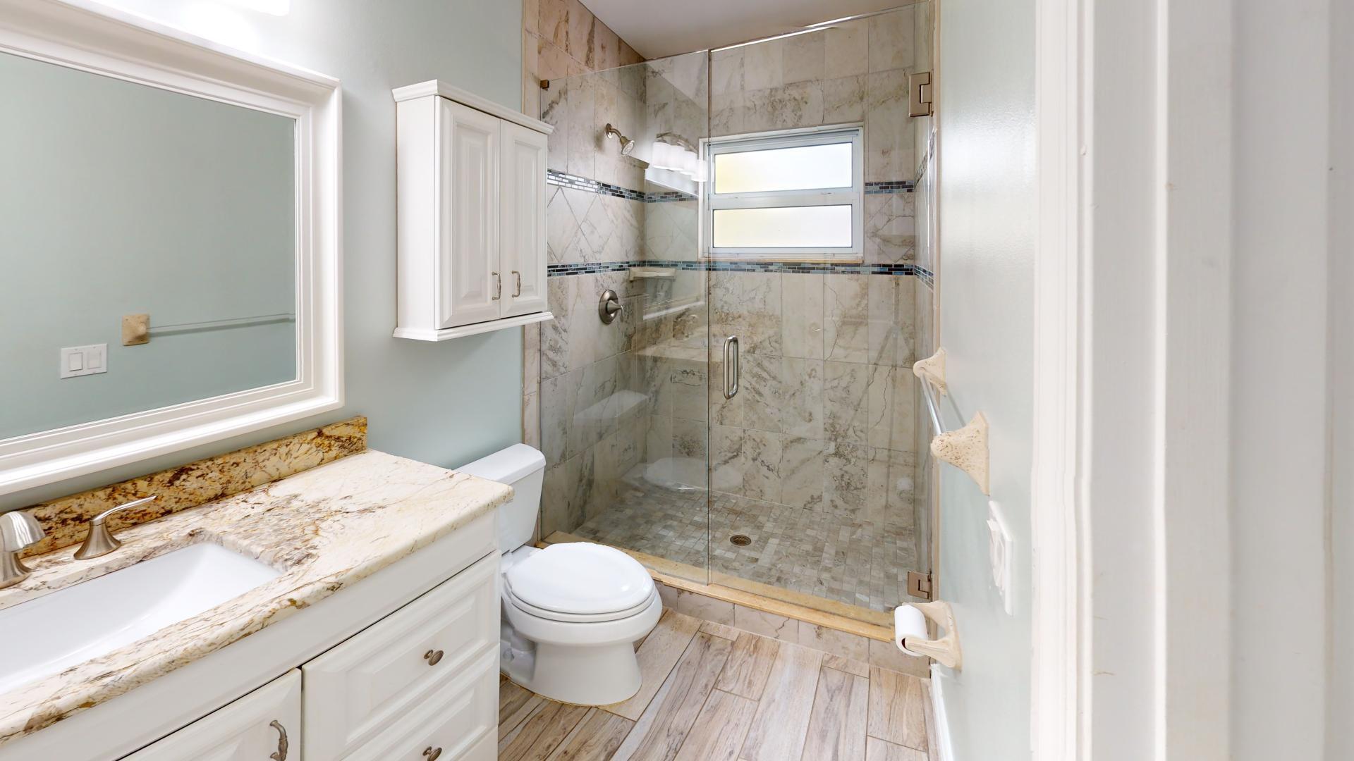 959 N Highway Indialantic, FL 32903 - Photo 52 of 70 a bathroom with a granite countertop shower a toilet and a sink