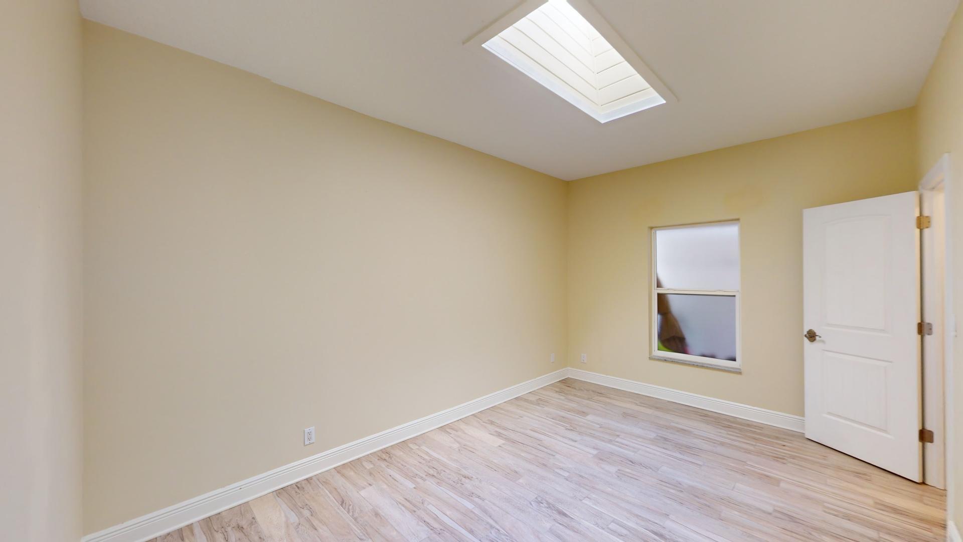 959 N Highway Indialantic, FL 32903 - Photo 55 of 70 an empty room with wooden floor and windows