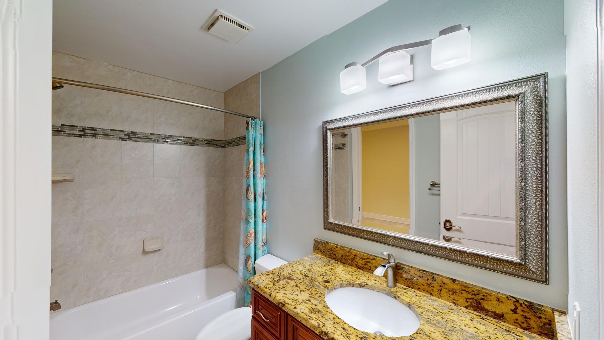 959 N Highway Indialantic, FL 32903 - Photo 58 of 70 a bathroom with a granite countertop sink mirror vanity and a bathtub