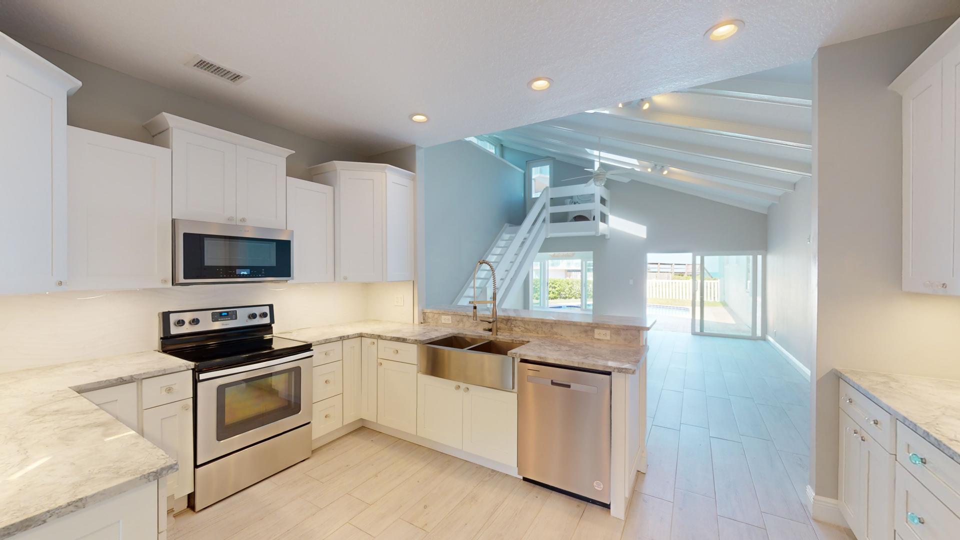 959 N Highway Indialantic, FL 32903 - Photo 9 of 70 a kitchen with granite countertop a stove and a sink